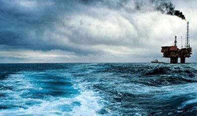 an oil rig next to the ocean