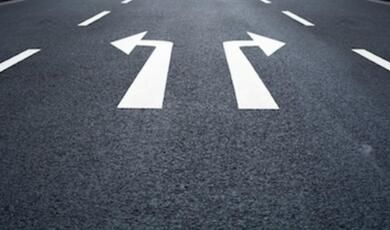 road surface showing two arrows pointing in different directions