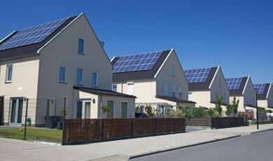 Photograph of rows of housing with solar panels