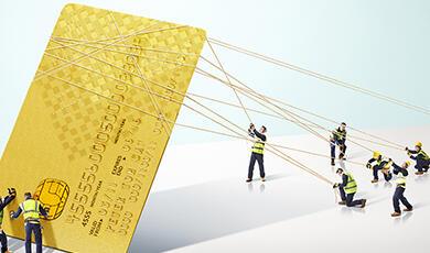 Little toy workmen hoisting up a credit card