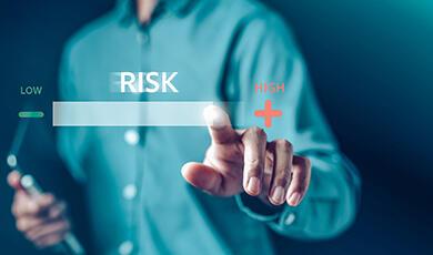 a graphic of a man pressing a graphic of the word 'risk'