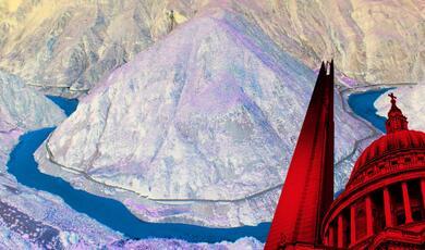 a river running around a mountain range