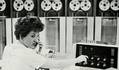 Lady operating early computer 1960s