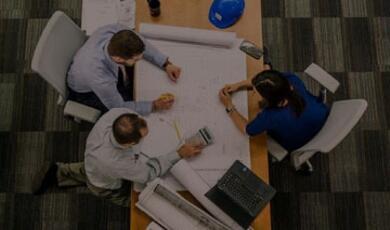Photo of people sitting at a desk in meeting
