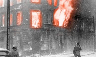 burning house with German soldier in foreground