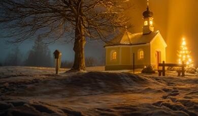 small, snowbound church lit up at night