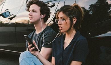 sitting couple sharing headphones