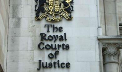 Royal Courts of Justice outside sign on wall