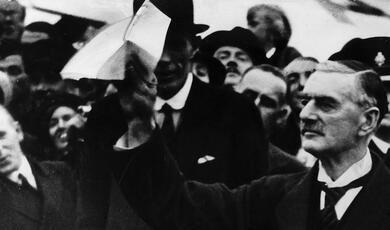 Neville Chamberlain holding white paper