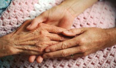 elderly hands embracing each other