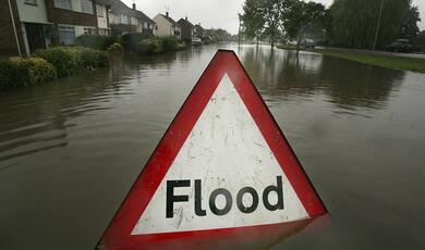 Flood triangular warning road sign