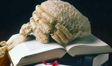 Legal wig resting on open book