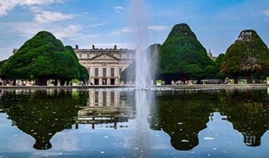 Hampton Court palace, reflected in a lake in the foreground