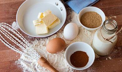 butter, two eggs, a whisk, milk and flour