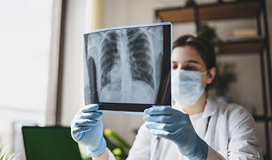 a woman examining an x-ray of a chest