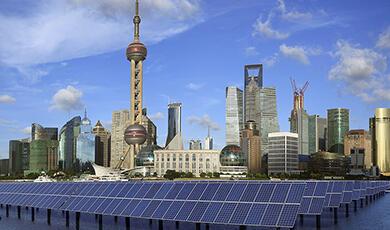 Field of solar panels outside a modern city