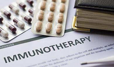 Text reading Immunotherapy next to two sachets of tablets
