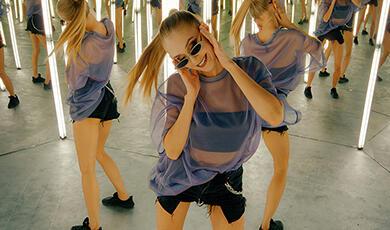 an image of a woman wearing sunglasses dancing