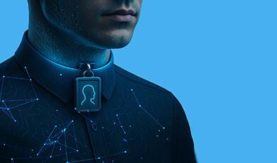 A man with digital patterns on his face and shirt, wearing a glowing pendant with a human profile icon around his neck, against a blue background