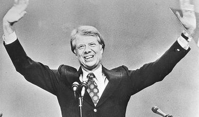 Jimmy Carter arms raised after addressing rally