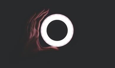 hand holding an illuminated circle