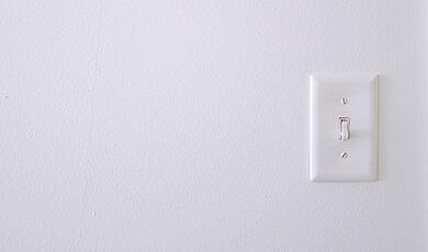 White light switch on white wall