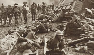 injured soldiers stretchered  not far from the battlefield
