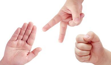 hands playing rock paper scissors